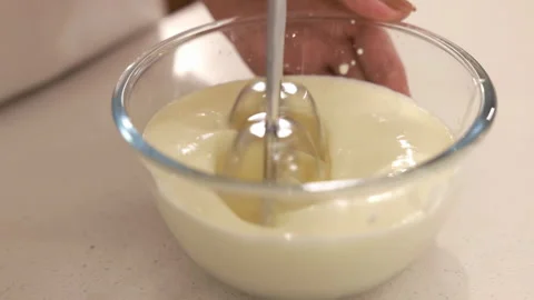 Pastry chef hand adds sugar and flour in white bowl whipping raw egg whites Stock Footage 339380449
