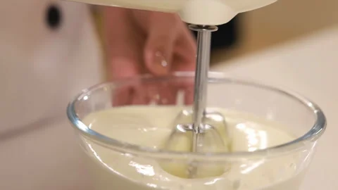 Pastry chef hand cooking adds sugar flour in white bowl whipping raw egg whites Stock Footage 339380530