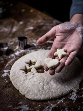 Pastry chef hand use cutting mold to cut Cookie dough on kitchen table. 스톡 사진