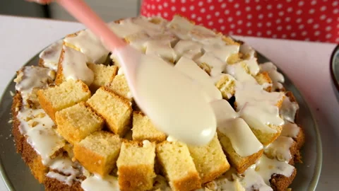 Pastry chef hands cooking pouring white cream on chocolate vanilla cake cubes. Stock-Footage 311537866