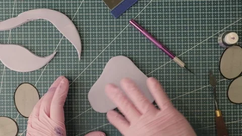 Pastry chef hands in a pink gloves making figurines out of sugar paste Stock Footage 303970835