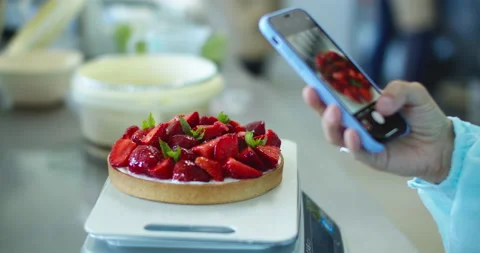 A pastry chef has prepared a cake with strawberries Stock Footage 133740522