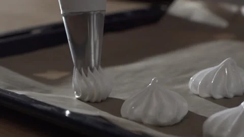 The pastry chef makes meringues on the baking paper extreme close up 库存影片 130356680