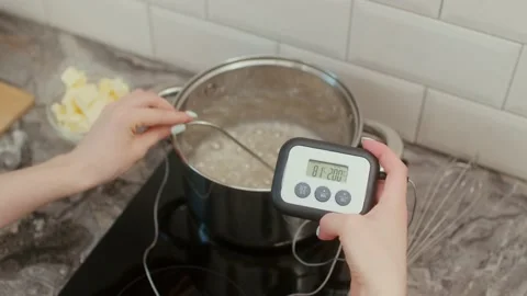 The pastry chef measures the temperature of caramel syrup in a bowl Stock-Footage 197685442