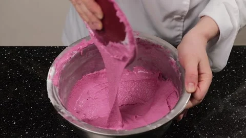 The pastry chef mixes the dough for the macarons in a stainless steel bowl. Stock Footage 150895564