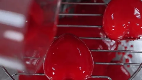 The pastry chef pours liquid syrup on mousse cakes. Desserts with mirror glaze. Stock Footage 136834881