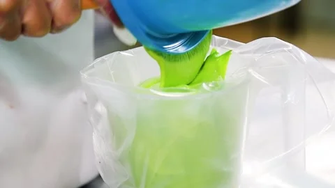 Pastry chef prepares colored glaze to decorate gingerbread cookies and ginger Video stock 205062793