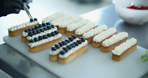 A pastry chef prepares a dessert in a pastry shop. Close-up of hands. Stock Footage 134347488