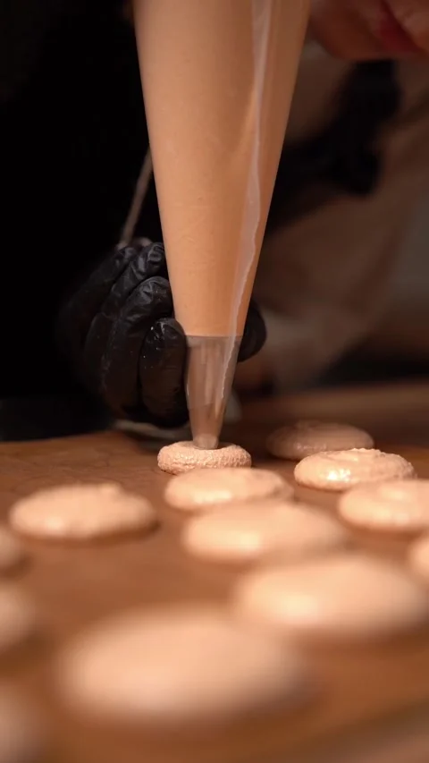 Pastry chef prepares sweet macaroon dessert. Macaroon baking pan. Macaron baking Video stock 294720457