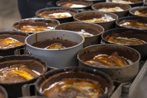 Pastry chef preparing and baking stack of chocolate crust for salty caramel.. Foto stock