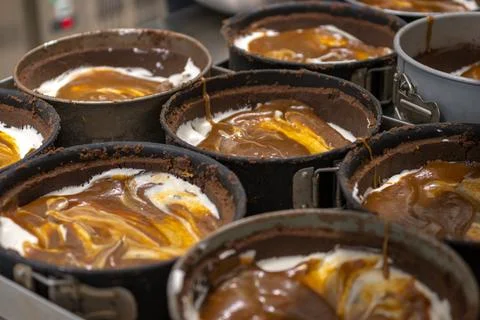 Pastry chef preparing and baking stack of chocolate crust for salty caramel.. 库存照片