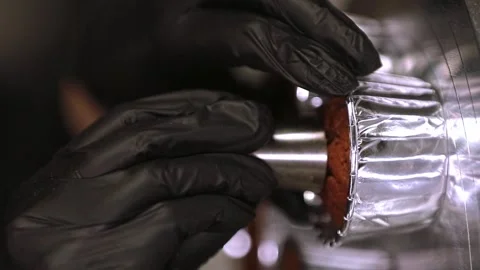 Pastry chef preparing cupcakes, hands making a hole in the cupcake for filling,  Stock Footage 297623908