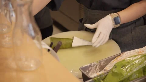 Pastry chef preparing a delicate green matcha crepe dessert Stock Footage 340253687