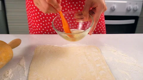 Pastry chef preparing dessert with dough mixing egg white in bowl on kitchen. Stock Footage 313041255