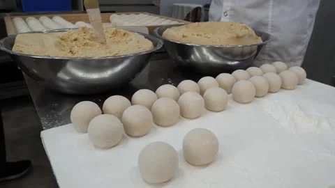 Pastry Chef Preparing Round Dough Balls in Commercial Kitchen Stock-Footage 345292022