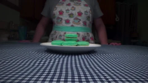 Pastry chef presents a plate of macarons and takes a bite Video stock 168468495