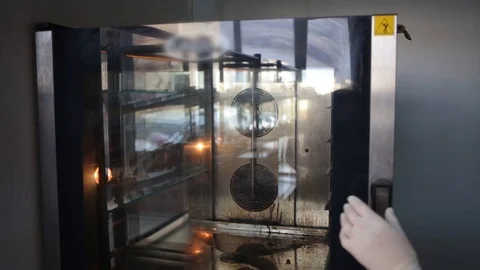 Pastry chef puts buns in the oven for baking Stock Footage 124273687