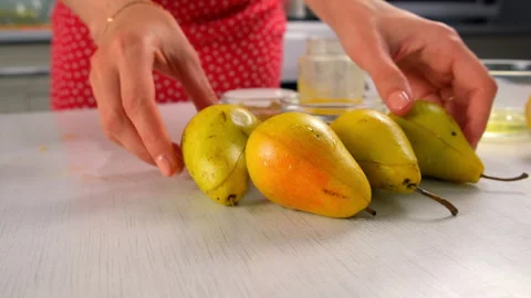 Pastry chef puts pears with nuts filling on table cooking dessert on kitchen. Stock Footage 313039328