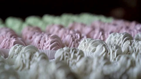Pastry chef puts ready-made marshmallow sprinkled with powdered sugar on a board Stock Footage 217481520