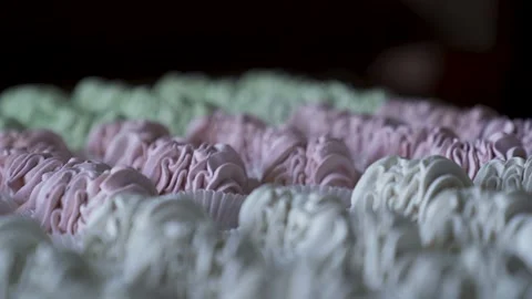 Pastry chef puts ready-made marshmallow sprinkled with powdered sugar on a board Stock Footage 221468181