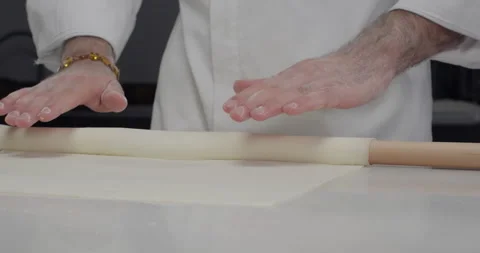 Pastry chef roll out phyllo dough with a rolling pin. Traditional Turkish Stock Footage 277851171