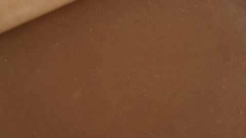 Pastry chef rolls out gingerbread cookie dough texture with wooden rolling pin Stock Footage 337500436