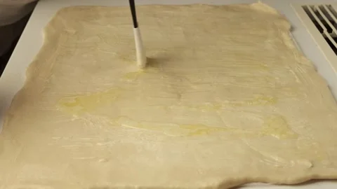 Pastry chef rolls out yeast dough using a rolling pin Vídeos de archivo 337069543