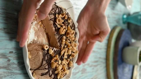 A pastry chef serves chocolate hazelnut semifreddo on the table. Vertical video. Stock Footage 305154794