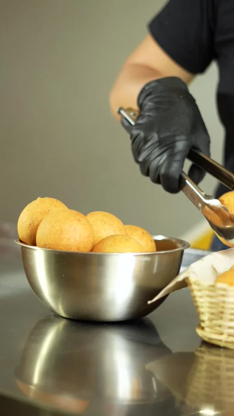 Pastry chef serving cheese buns or bunuelos in a basket ready to enjoy Stock Footage 286165193