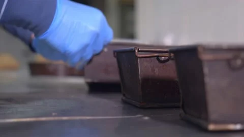 Pastry chef shakes the mold to level the chocolate - blurred Stock Footage 227511606