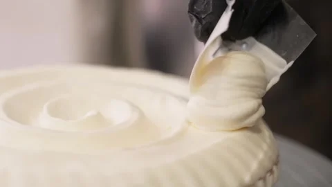 Pastry Chef Spreading Smooth White Cream Coating on Gourmet Dessert Pie Stock Footage 337751499