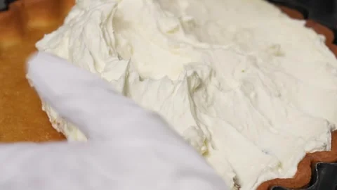 Pastry Chef Spreading Thick Whipped Cream Over Freshly Baked Pie Crust Stock Footage 337751157