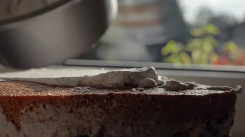 Pastry chef spreading white cream on a cake Stock Footage 94262880
