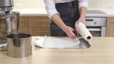 The pastry chef spreads parchment on a baking sheet Video stock 231250890