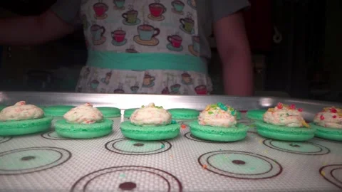 Pastry Chef sprinkles cereal on macarons Video stock 168467175