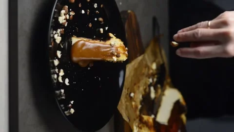 The pastry chef sprinkles the cheesecake with nuts. Vertical video Stock Footage 248775076