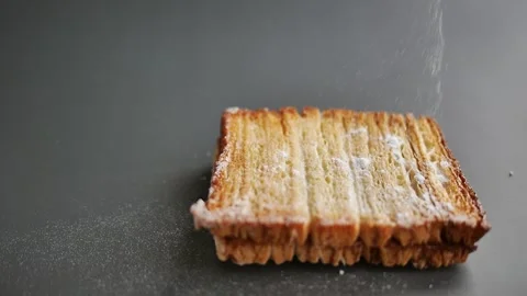 Pastry Chef sprinkling icing sugar on the puff pastry named Butterwind, onl.. Stock Footage 307403533