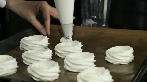 Pastry chef squeezes the cream on a baking sheet. Stock Footage 96380306