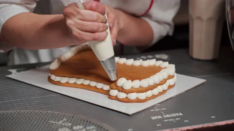 The pastry chef squeezes the cream onto the cake. Close-up Stock Footage 167267791