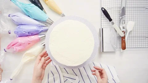 Pastry chef stacking cake layers Stock Footage 95620889