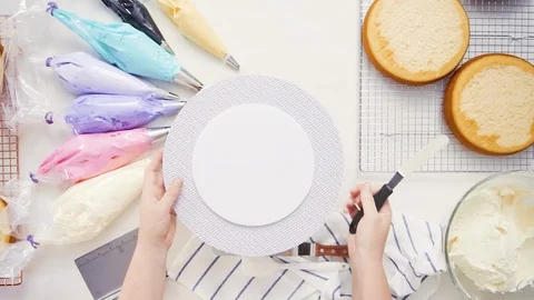 Pastry chef stacking cake layers Stock Footage 95621031