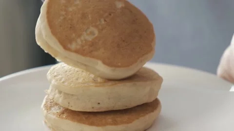 Pastry chef stacking pancakes on plate. Stock Footage 168478424
