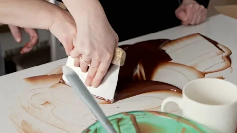 Pastry chef teaching to work with tempering chocolate using spatula on table. Stock Footage 236897782