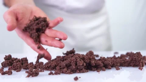 Pastry chef throwing chocolate chip on a white table. Stock Footage 130853272