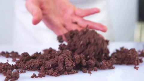 Pastry chef throwing chocolate chip on a white table. Stock Footage 141561461