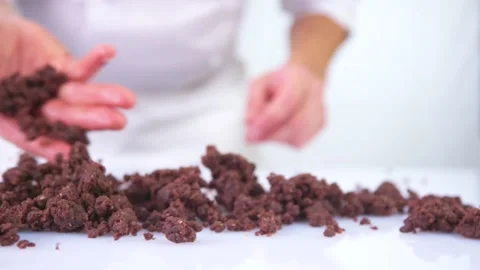 Pastry chef throwing chocolate chip on a white table. Stock Footage 141969848