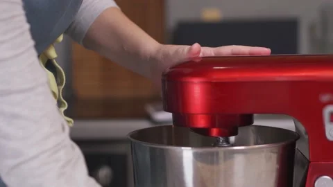 The pastry chef turns on the red planetary mixer. Close-up Stock Footage 147578255