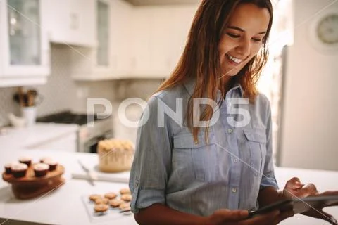 Pastry chef using digital tablet in kitchen Stock Photos
