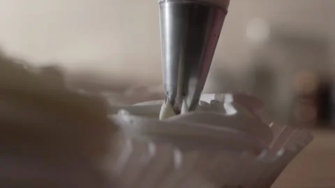 The pastry chef using a pastry bag for a cake extreme close up Video stock 130356642