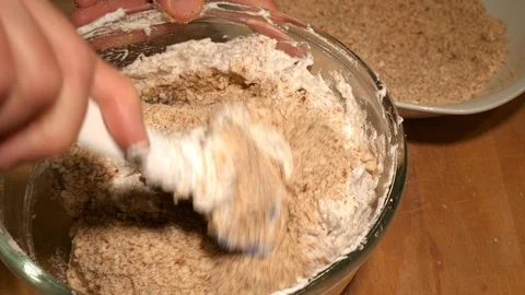 Pastry chef at work: Mix egg white and almond flour with spatula, top view Stock Footage 86874130